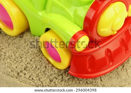 Close-up Of Toy Truck On the Kinetic Sand Heap Summer Beach Game Concept.