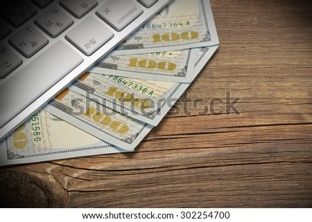 Computer Keyboard  And Dollar Cash On The Rough Wood Background. E-commerce Or Freelance Work Concept