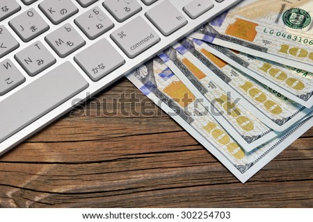 Computer Keyboard  And Dollar Cash On The Rough Wood Background. E-commerce Or Freelance Work Concept