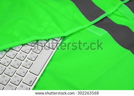 Keyboard In The Green Reflective Safety Vest  Technical Or Road Assistance Or Professional Help Concept With Copy Space