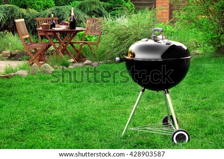 Scene Of Family Barbecue Grill Party Or Picnic On The Lawn In The Backyard At Summertime Weekend.