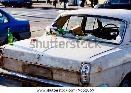 Dump of waste products in the broken thrown car