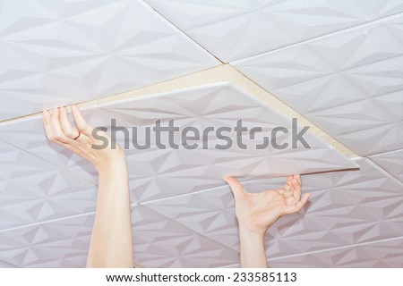 Installation of ceiling tiles made of polystyrene