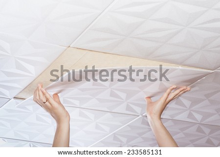 Installation of ceiling tiles made of polystyrene
