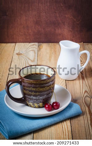 pitcher, cherry, coffee in a cup