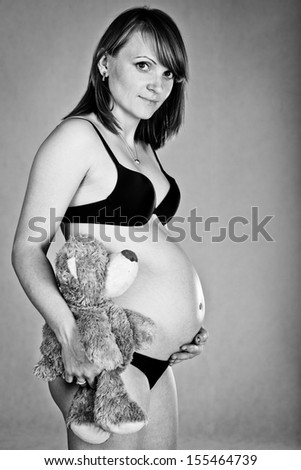 Pregnant woman with teddy bear (black and white)