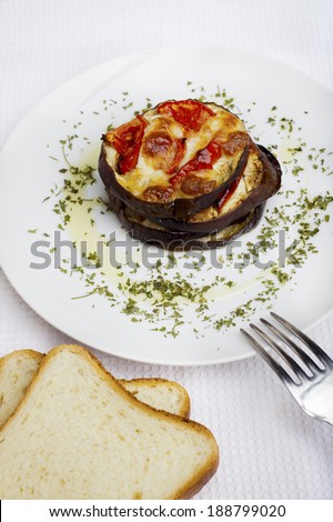 sliced Ã?Â¢??Ã?Â¢??eggplant baked with cherry tomatoes and parmesan cheese