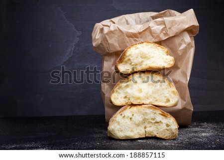 fresh broken bread in paper bag
