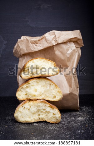 fresh broken bread in paper bag