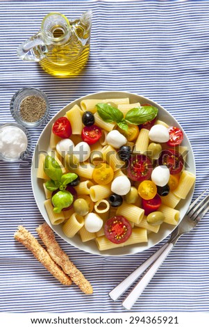 pasta salad on blue striped tablecloth. Italian Summer easy healthy recipe