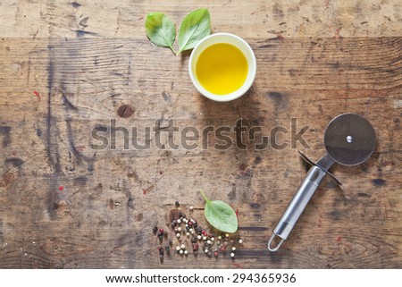Wooden food background for recipes,  space for writing or placing text menu. olive oil, basil, black and red pepper, knife for pizza