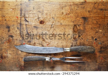 carving set for meat\
on the old wooden background . background for restaurants