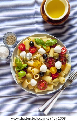 pasta salad on blue striped tablecloth. Italian Summer easy healthy recipe