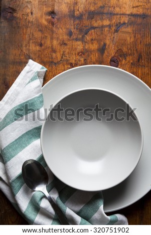 A set of plates on a wooden table. table setting