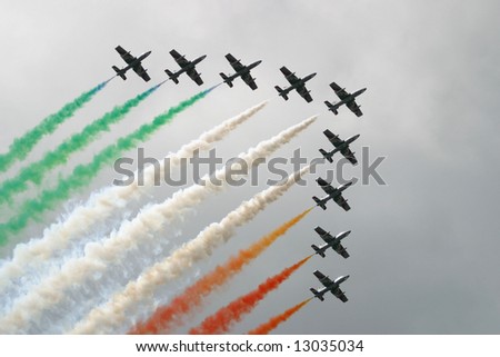 Italian squadron of nine aircrafts with coloured smoke traces symbolizing the Italian flag.