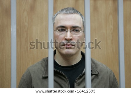 MOSCOW - APRIL 11: Mikhail Khodorkovsky, former owner of oil giant Yukos, stands behind bars of the defendant\'s cage during his trial for fraud and tax evasion April 11, 2005 in Moscow, Russia.
