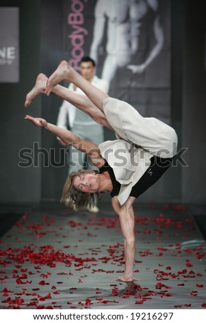 MOSCOW - OCTOBER 19: Model makes an acrobatic feat during the Body Boy Collection as part of Russian Fashion Week October 19, 2006 in Moscow, Russia.
