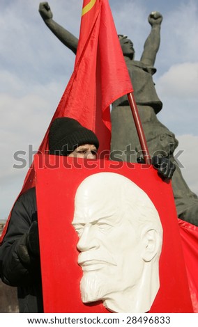 MOSCOW, MARCH 14: A man holds a portrait of the Soviet founder Vladimir Lenin during rally in central Moscow, Russia, March 14, 2009.