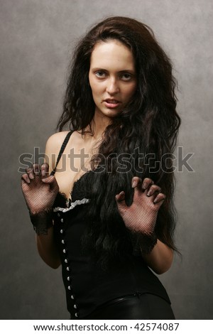 Girl in sexy outfit, gesturing in cat-like manner