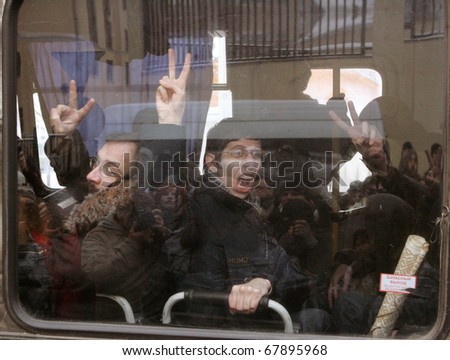 MOSCOW - DECEMBER 27: Supporters of Yukos oil company chief executive officer Mikhail Khodorkovsky show v-signs at a police bus during a rally outside the court December 27, 2010 in Moscow, Russia.
