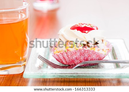 Vanilla roll cake with strawberry jam and Juice or softdrink.