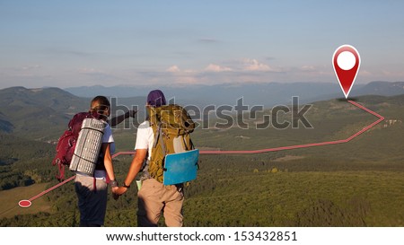 Concept of tourists couple with GPS Icons. Navigation on the mountains. Global Positioning System. Push pin pointing at mountain