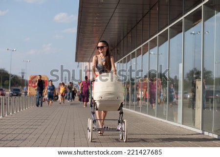 Stylish mom with retro stroller