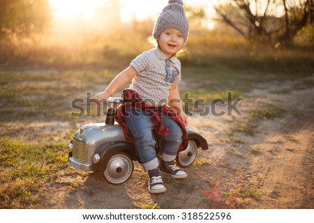 Toddler posing with toy race car
