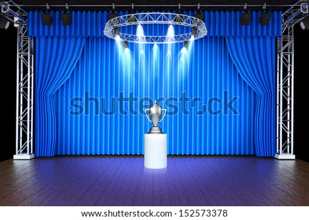 Silver trophy on theater stage blue curtains and spotlights