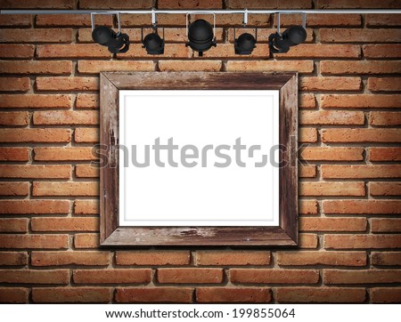 Old picture frame on wall with spotlight