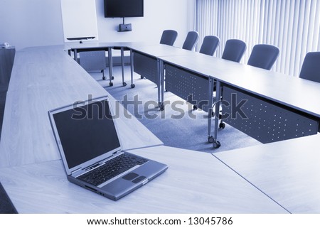 Board room in office block with laptop