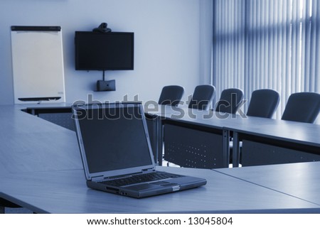 Board room in office block with laptop and video conferencing equipment