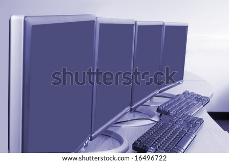 Computer screens and keyboards in training room