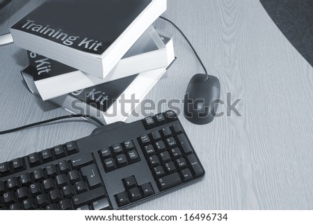 Computer training books with keyboard and mouse in college