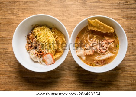 Thai noodle soup in a bowl taste spicy noodle soup on wooden background