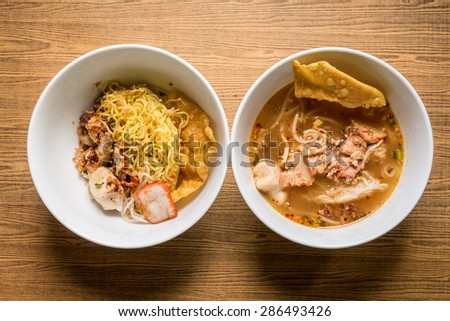 Thai noodle soup in a bowl taste spicy noodle soup on wooden background