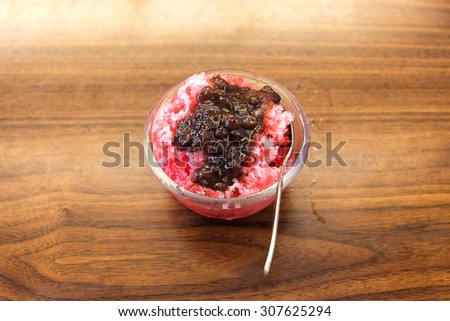 Traditional Japanese Dessert , A Bowl of Red Bean Sweet with red ice on wood pattern