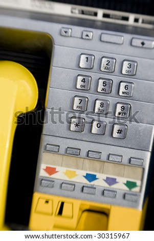 Vertical close-up image of a public pay phone keypad