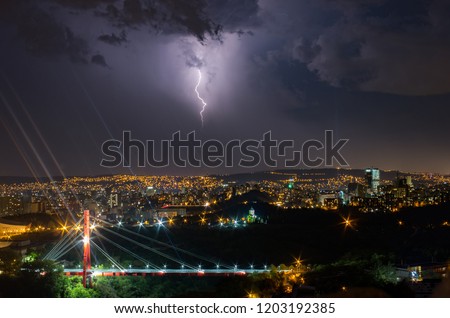 Lightning over the city at rainy night