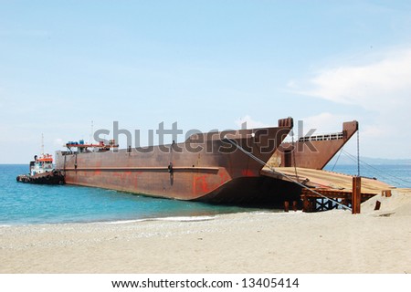 tugboat and barge docked at sea