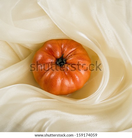 Red tomato in studio with white background