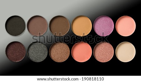 Make-up, colorful eye shadows palette on black background.