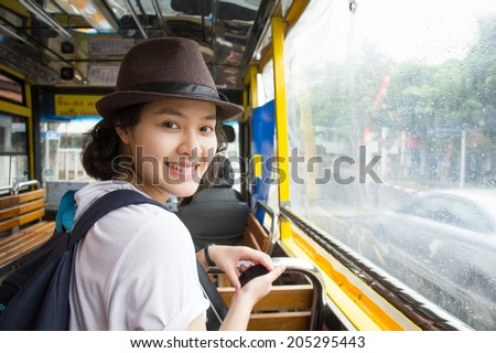 Young Asian woman in the bus with rainy day.