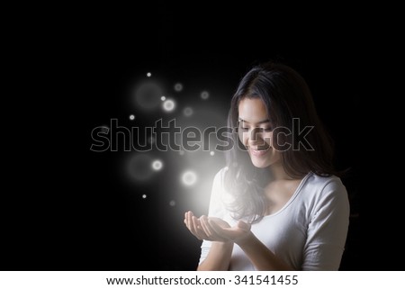 Young Asian woman opening hands with smiley face at night.