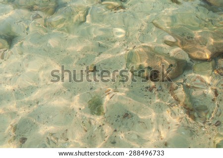 pebbles in clear water surface - shallow clear water