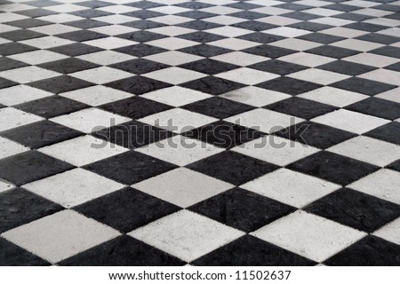A medieval black and white tiled floor. Stone texture. Shot at the \