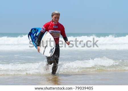 HOSSEGOR, FRANCE - JUNE 4: Dimity Stoyle runs back to the beach after she defeats Felicity Palmateer during the ASP Women\'s Pro Junior event semi-final June 4, 2011 in Hossegor, France.