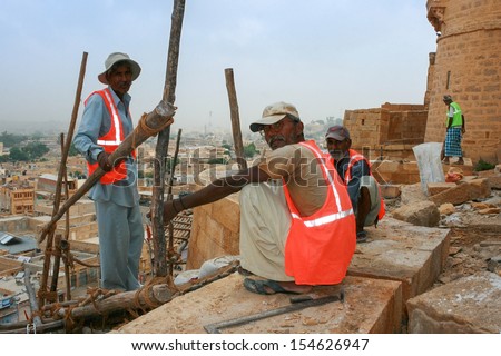 JAISALMER, RAJASTHAN, INDIA - OCT. 16: The builders work on the construction of the fort on OCT. 16, 2012 in Jaisalmer, Rajasthan, India.