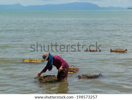 KEP, CAMBODIA, 07 JUN. 2014: Crab Catchers revise their traps at Kep, Cambodia, 07 Jun. Caught crabs immediately sent to numerous restaurants on the beach.