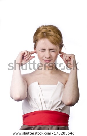 young blonde in a rage covers his ears with his hands
